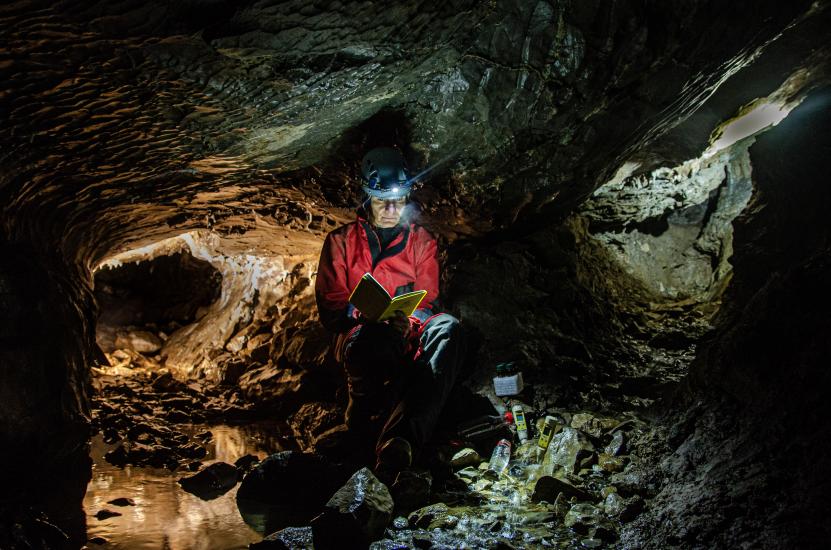 Collecting water samples from the Punkva River in the Amatérská Cave, Moravian Karst